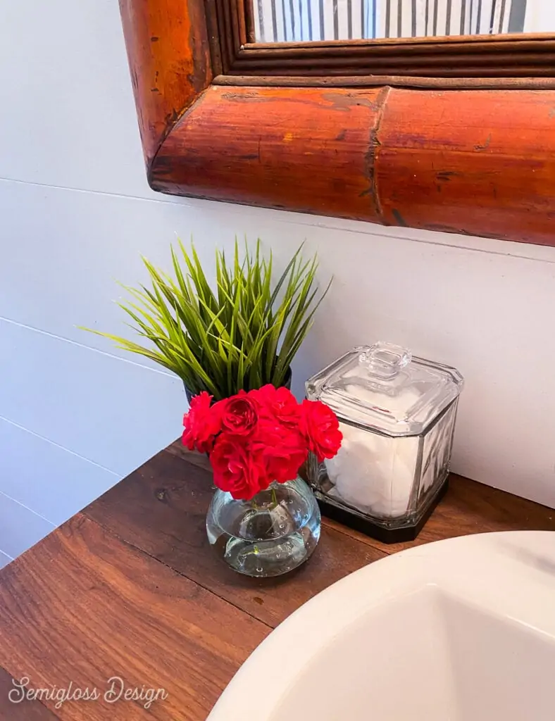 small vase of roses in bathroom