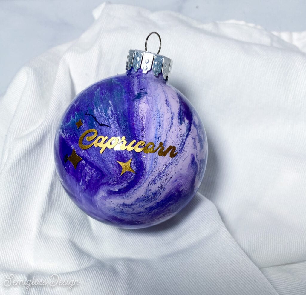 purple paint swirl ornament with "Capricorn" decal