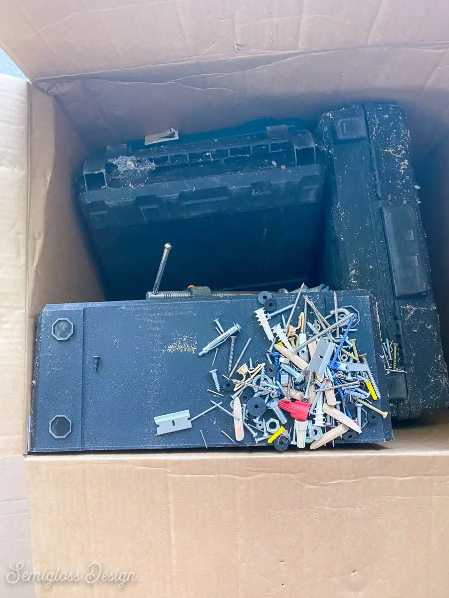 box with spilled nails and screws