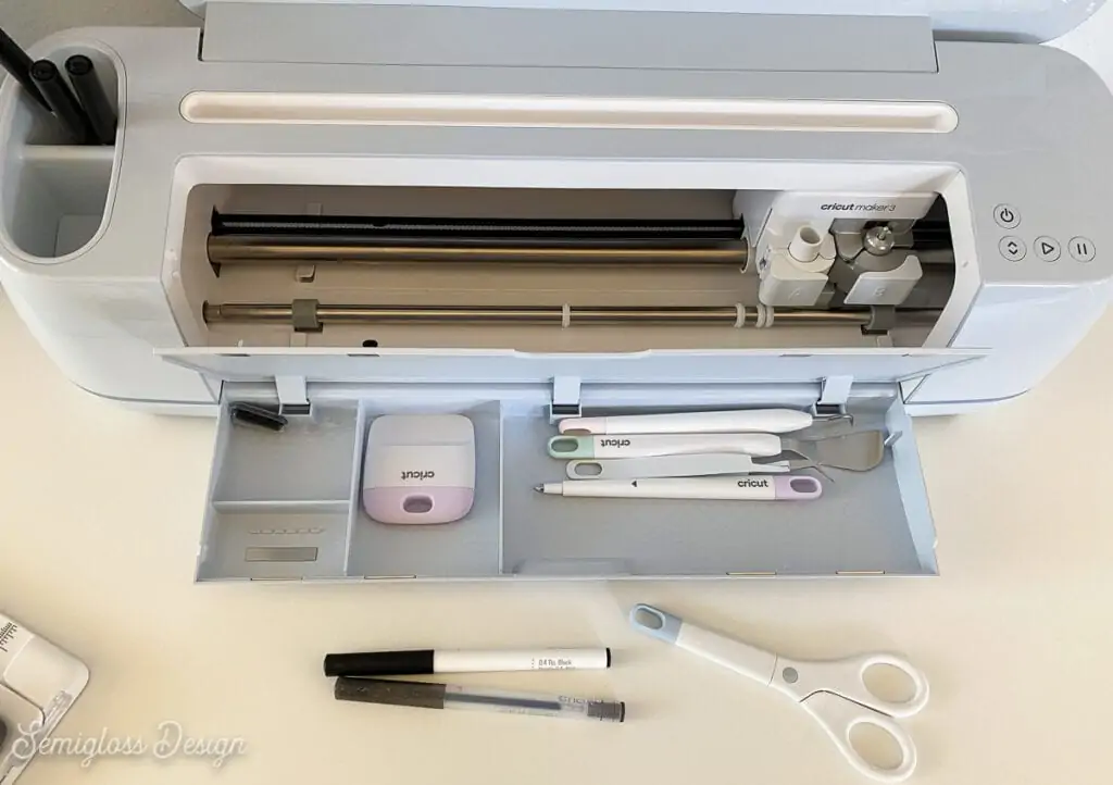 Cricut maker open with weeding tools in storage