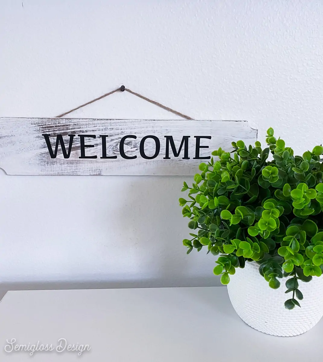 welcome sign with plant