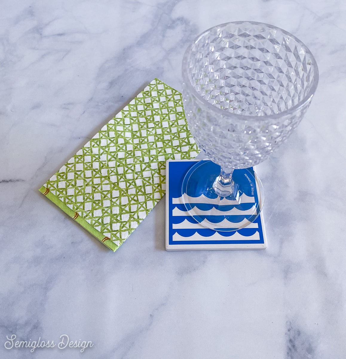 glass and coaster with blue waves