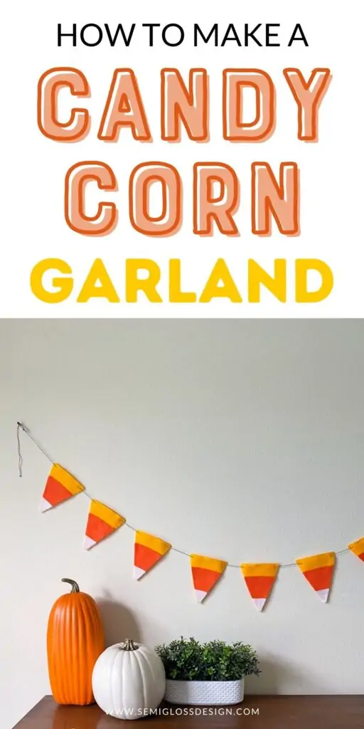 candy corn garland on wall with pumpkins on dresser