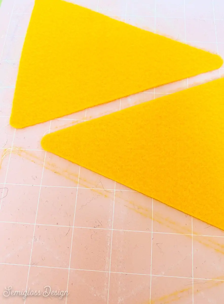 yellow felt triangles on pink cricut mat