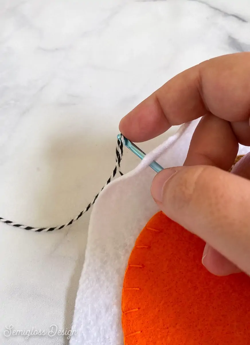 threading string through banner slits using crochet hook