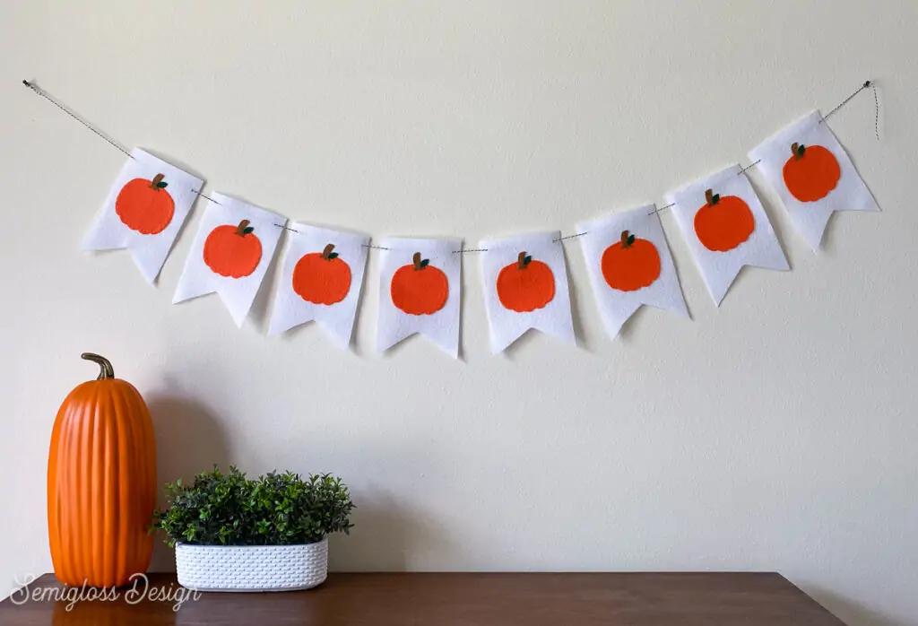 felt pumpkin banner hanging above dresser