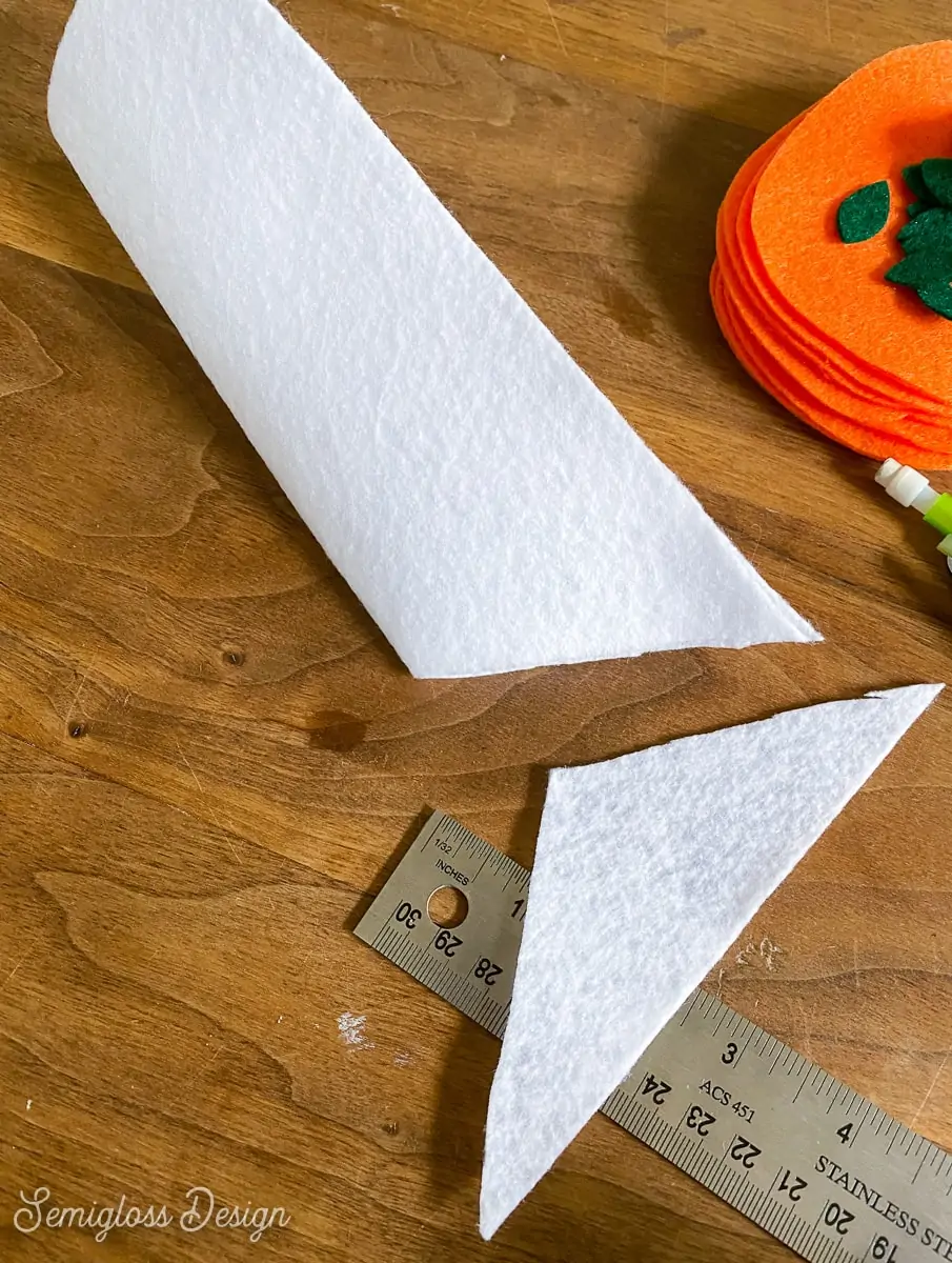 cutting triangle from folded felt to make banner flag