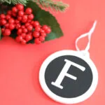 Monogram ornament with letter F on red background