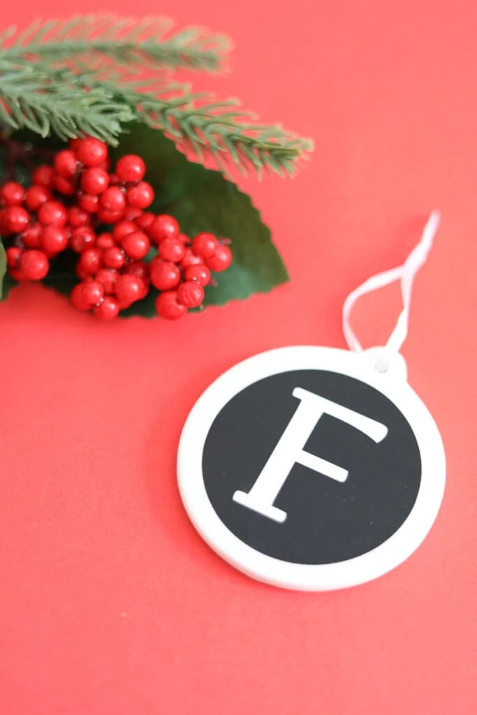Monogram ornament with letter F on red background
