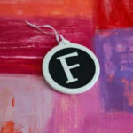 F monogram ornament on hand painted background