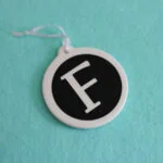 F monogram ornament on aqua background