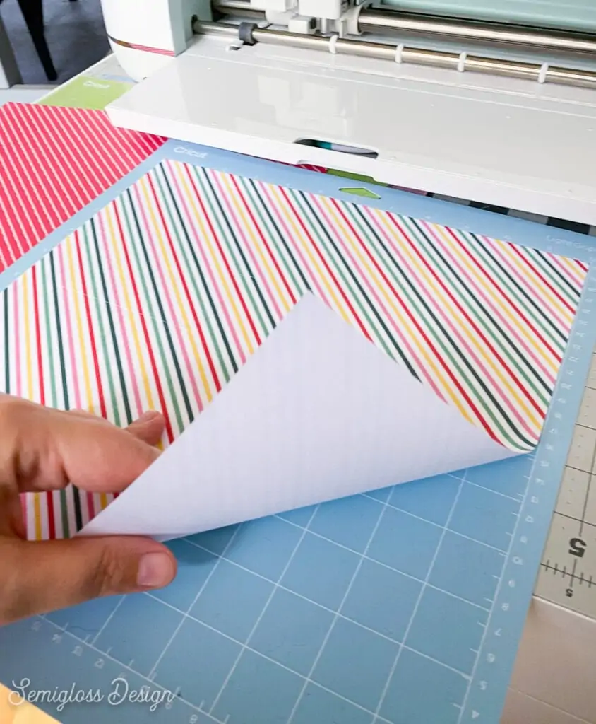 peeling striped paper from blue cricut mat