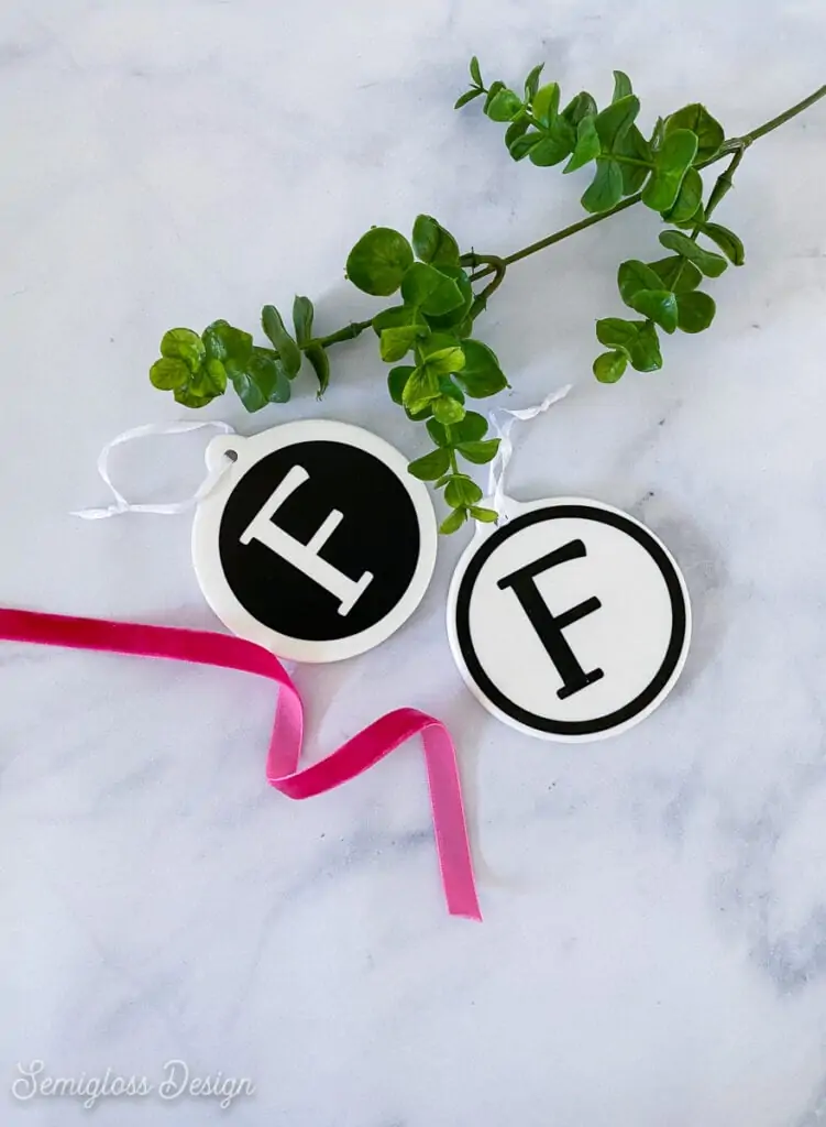 ornaments with letter F with ribbon and plant