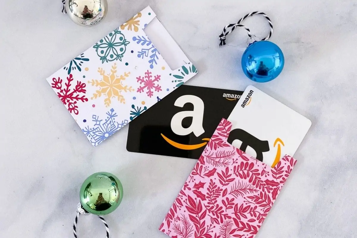 close up of gift card sleeves, gift card, and ornament