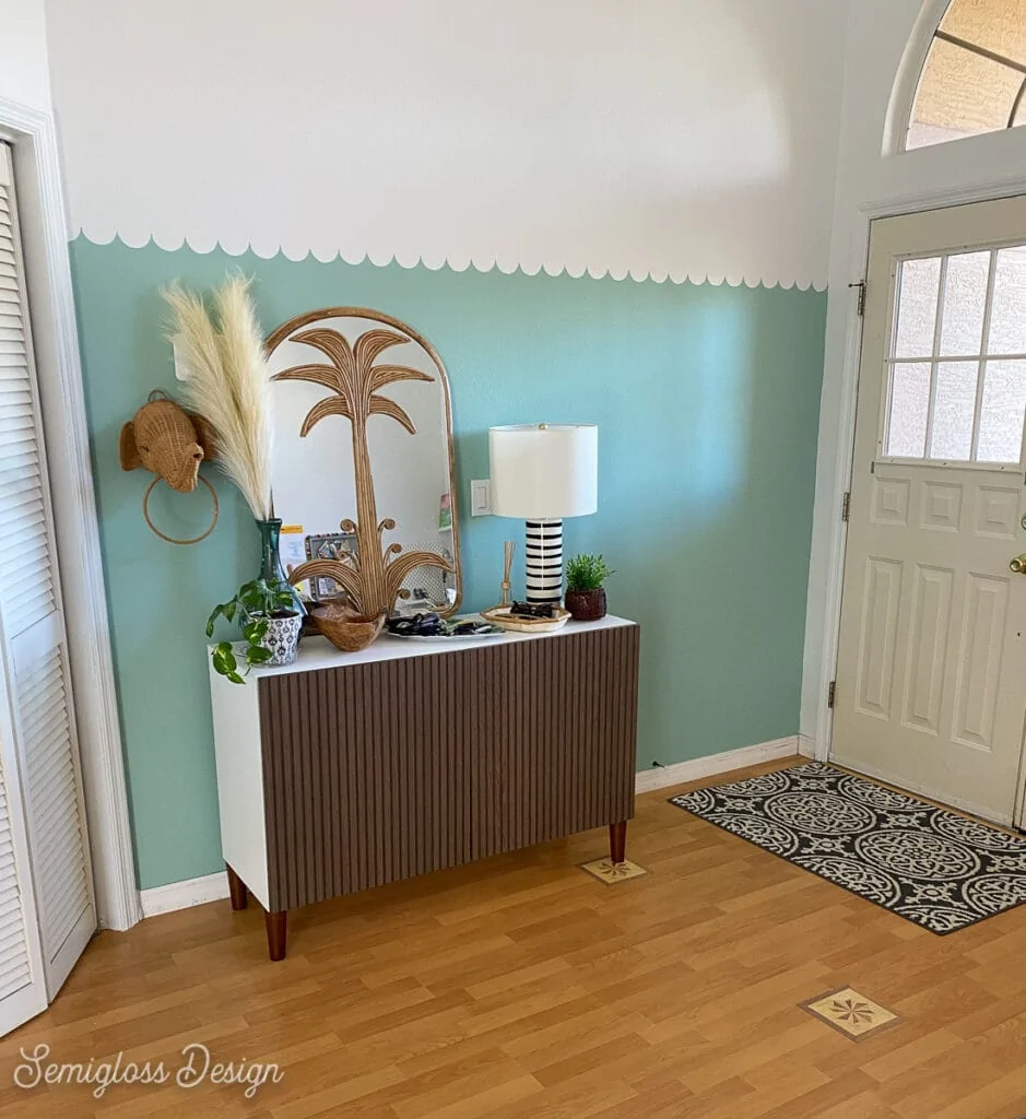 entryway with aqua scallop wall and boho mirror