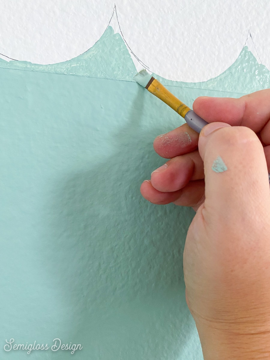 using craft brush to paint scallop wall details