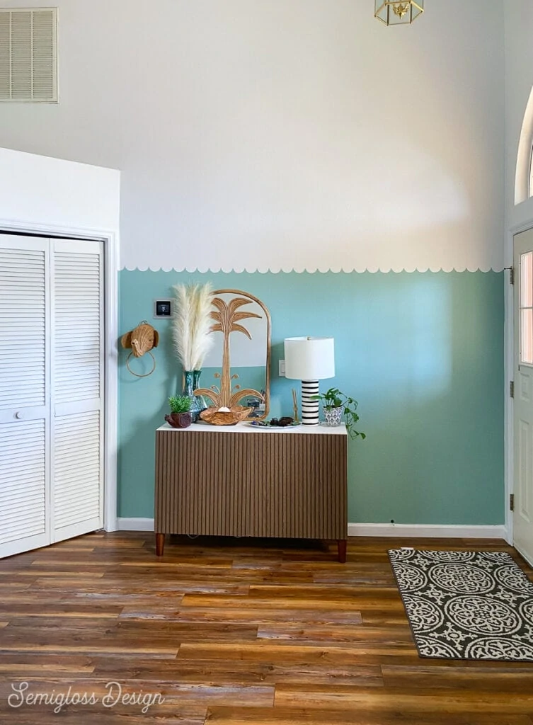 scalloped wall in entryway with high ceiling