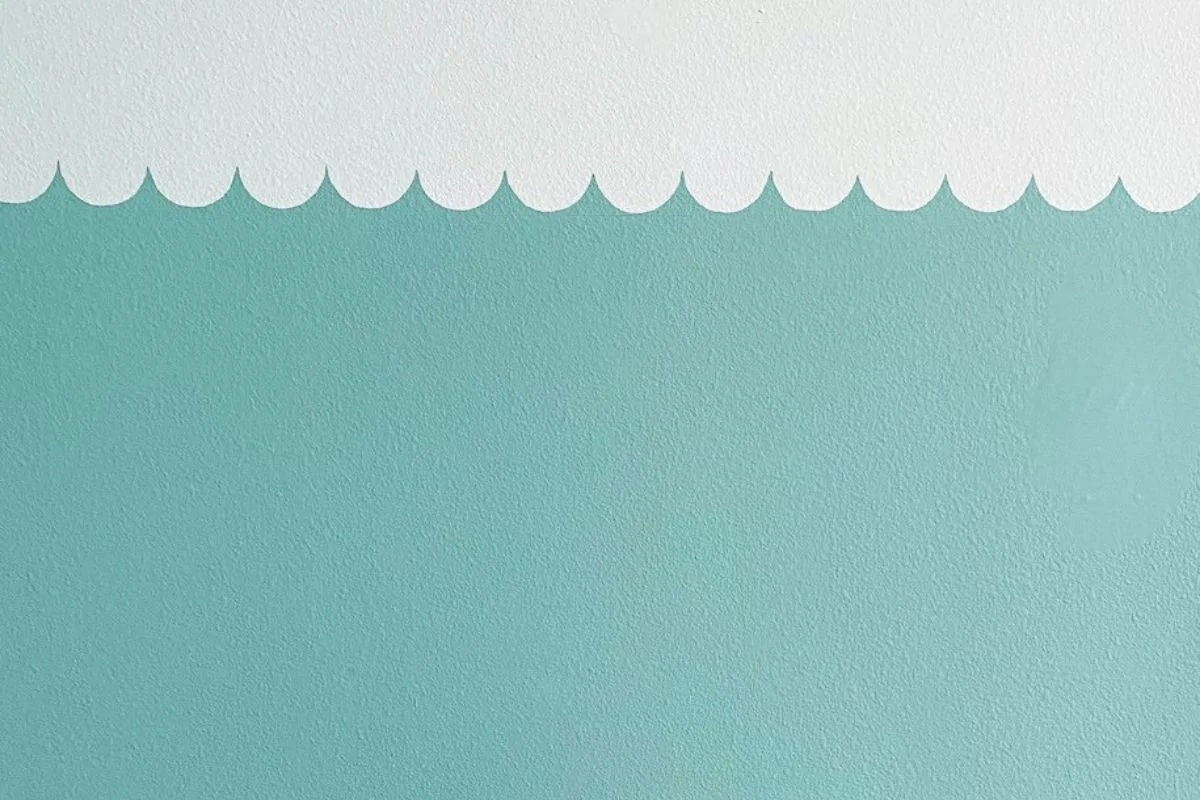 aqua painted scallop design painted on white wall