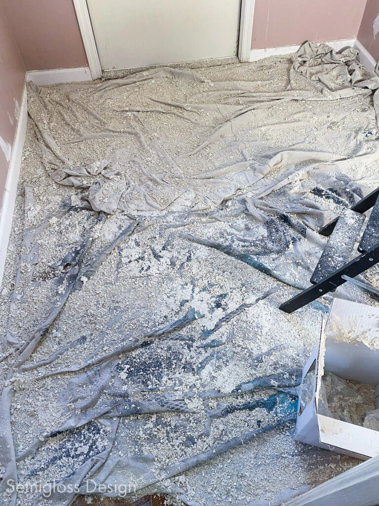 mess on floor after removing popcorn ceiling