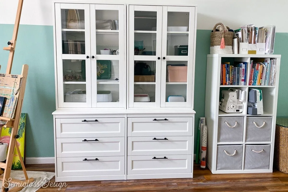 white cabinet and bookshelf