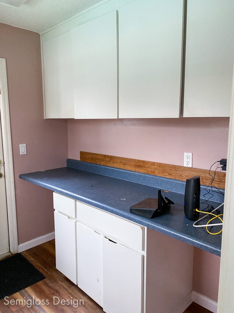 pink room with cabinets and blue countertop