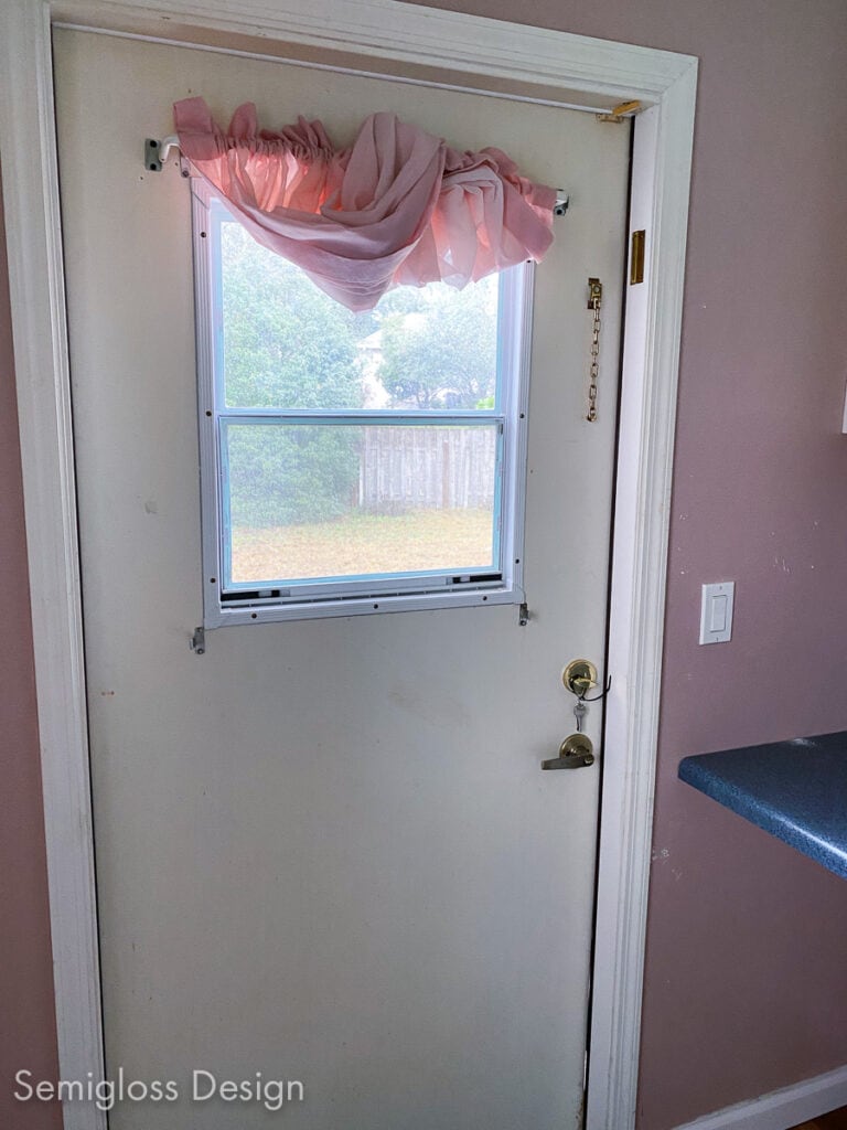 back door with pink curtain