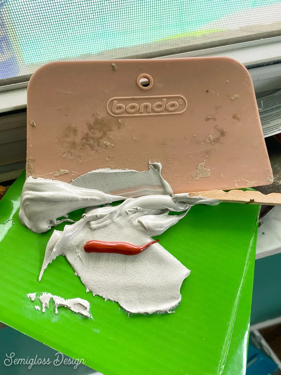 mixing bondo on a piece of cardboard