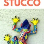 colorful ceramic frog art on wall