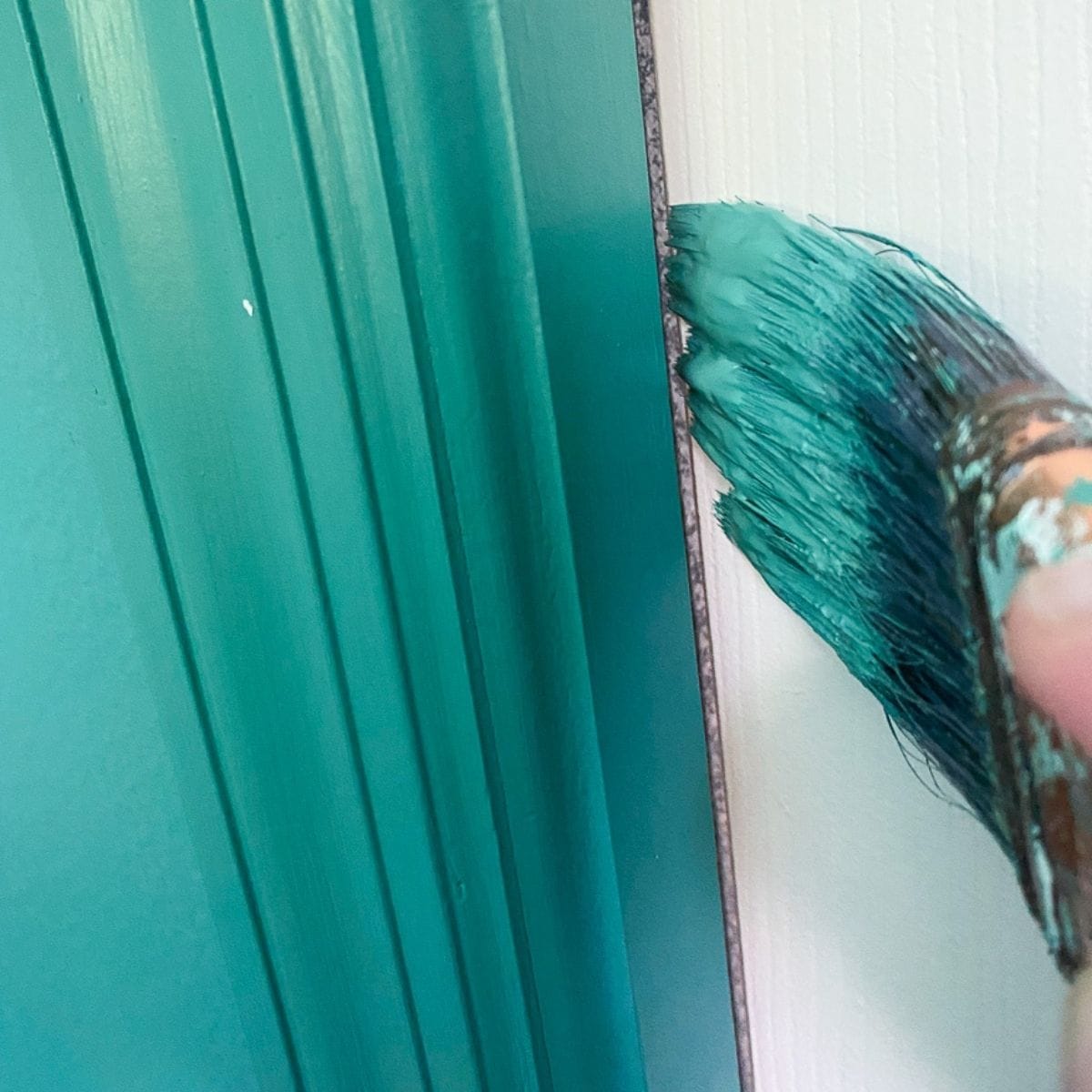 paint brush painting edge of pocket door
