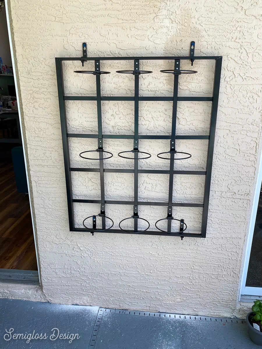 trellis with plant hangers on wall