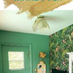 green office with colorful wallpaper on wall behind desk