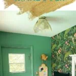 green office with colorful wallpaper on wall behind desk
