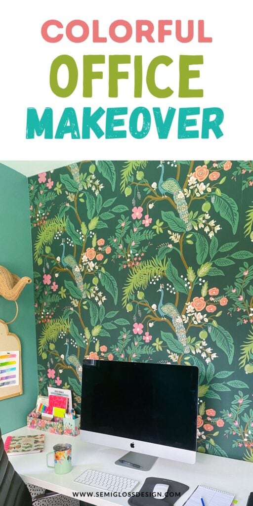 mac desktop on desk with colorful floral wallpaper on wall