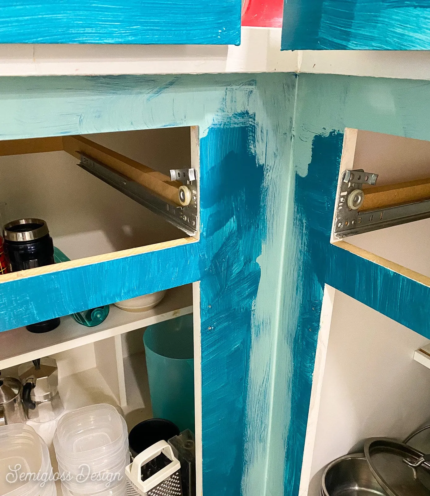 painting corners of cabinet with a paintbrush