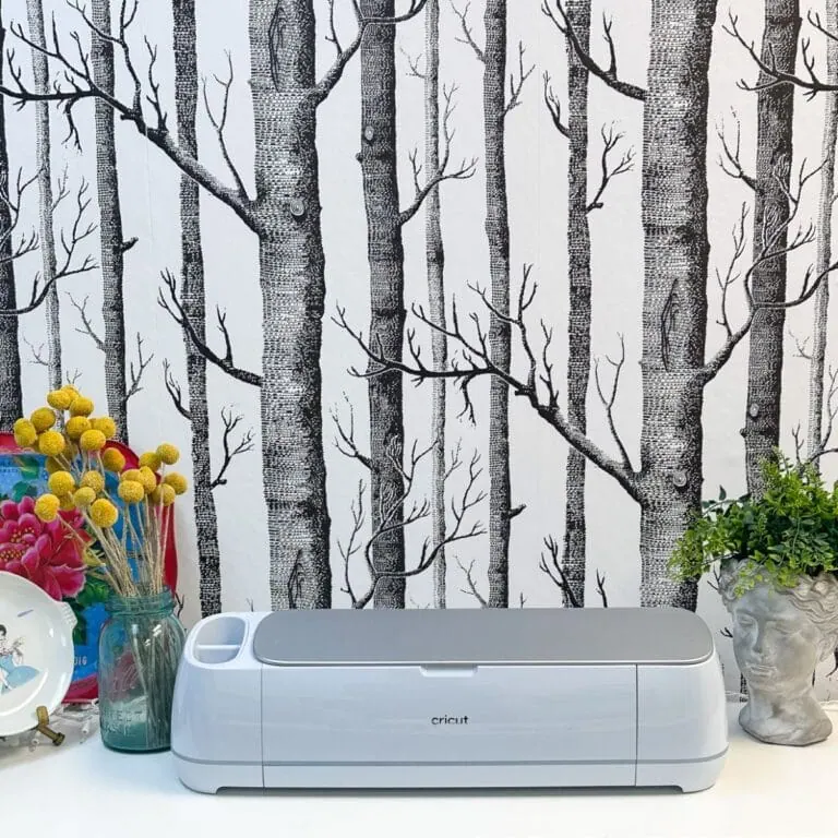 cricut maker on shelf with tree wallpaper
