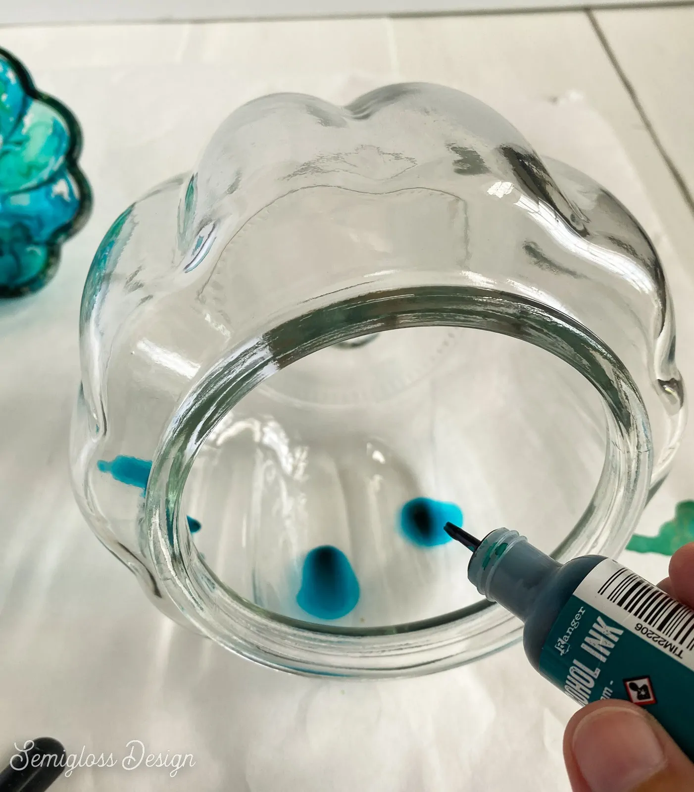 dropping alcohol ink inside glass pumpkin jar