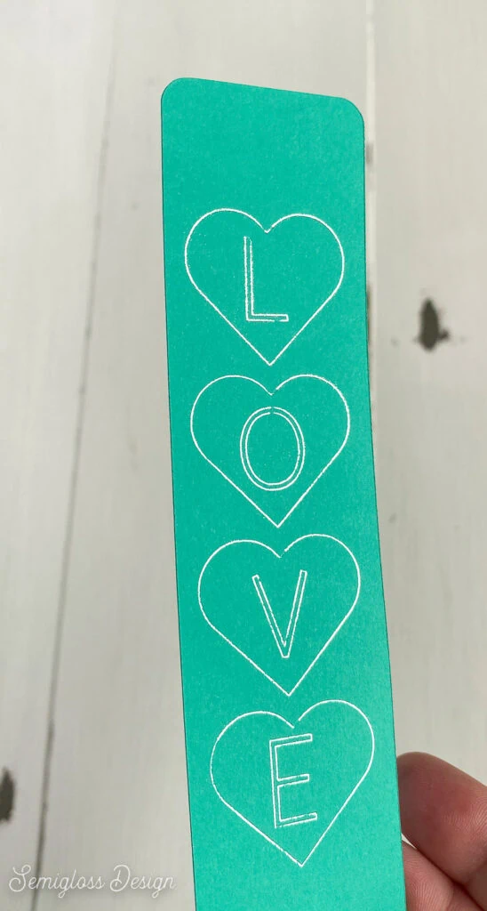 teal bookmark with silver lettering