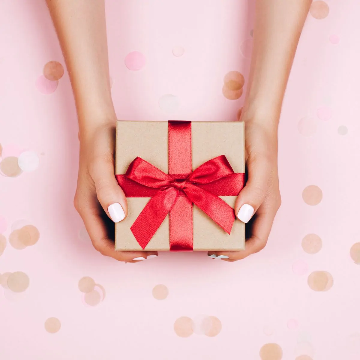 present with red bow on pink background