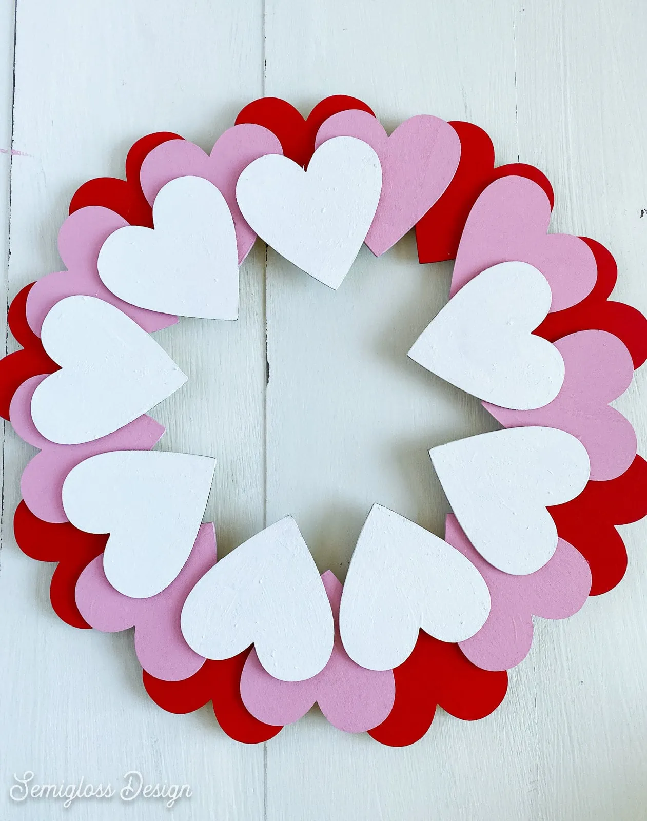 glued hearts on wooden wreath base