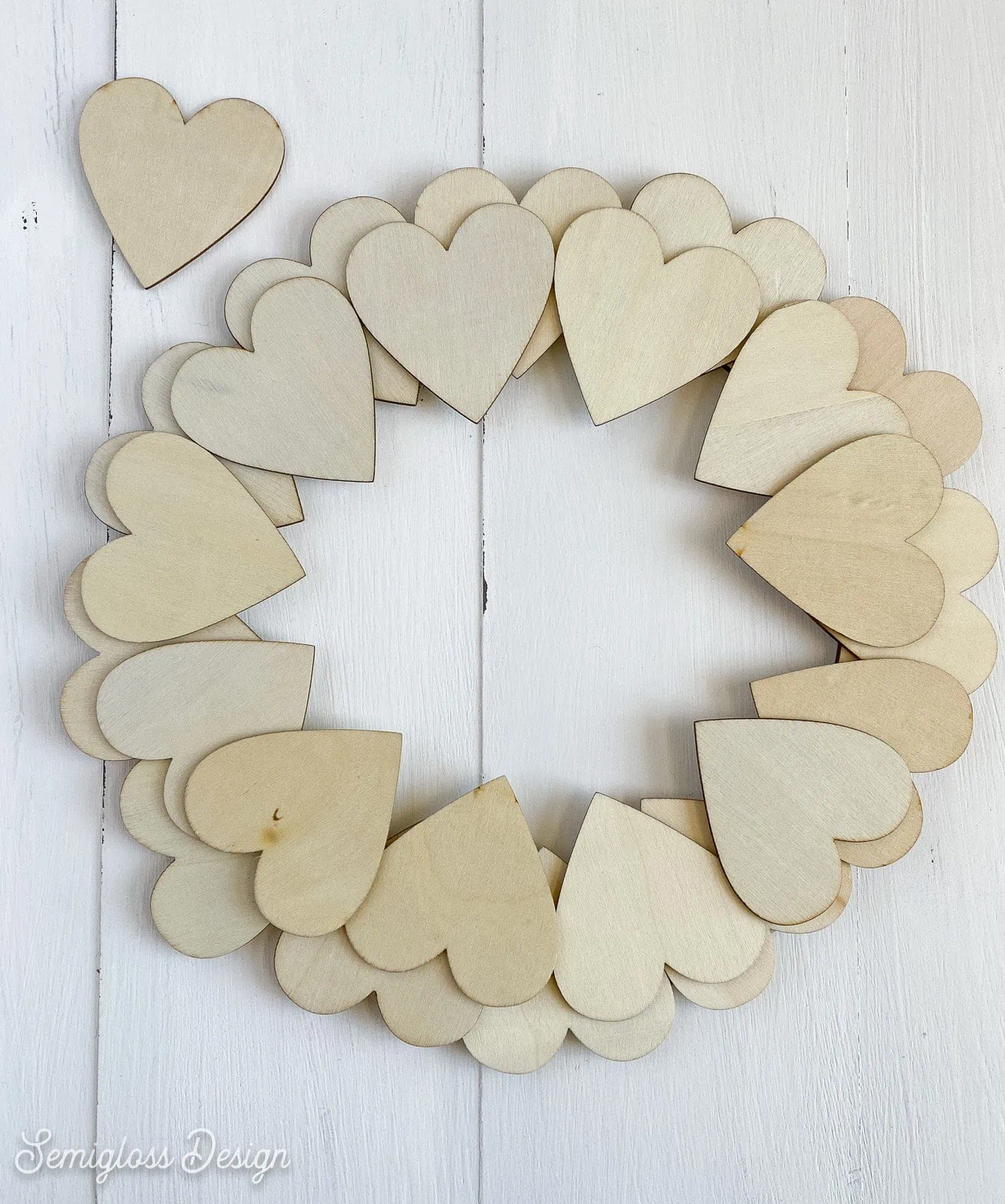 wooden hearts laid out on wreath form