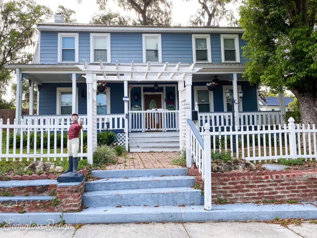 blue 2-story home with front porch