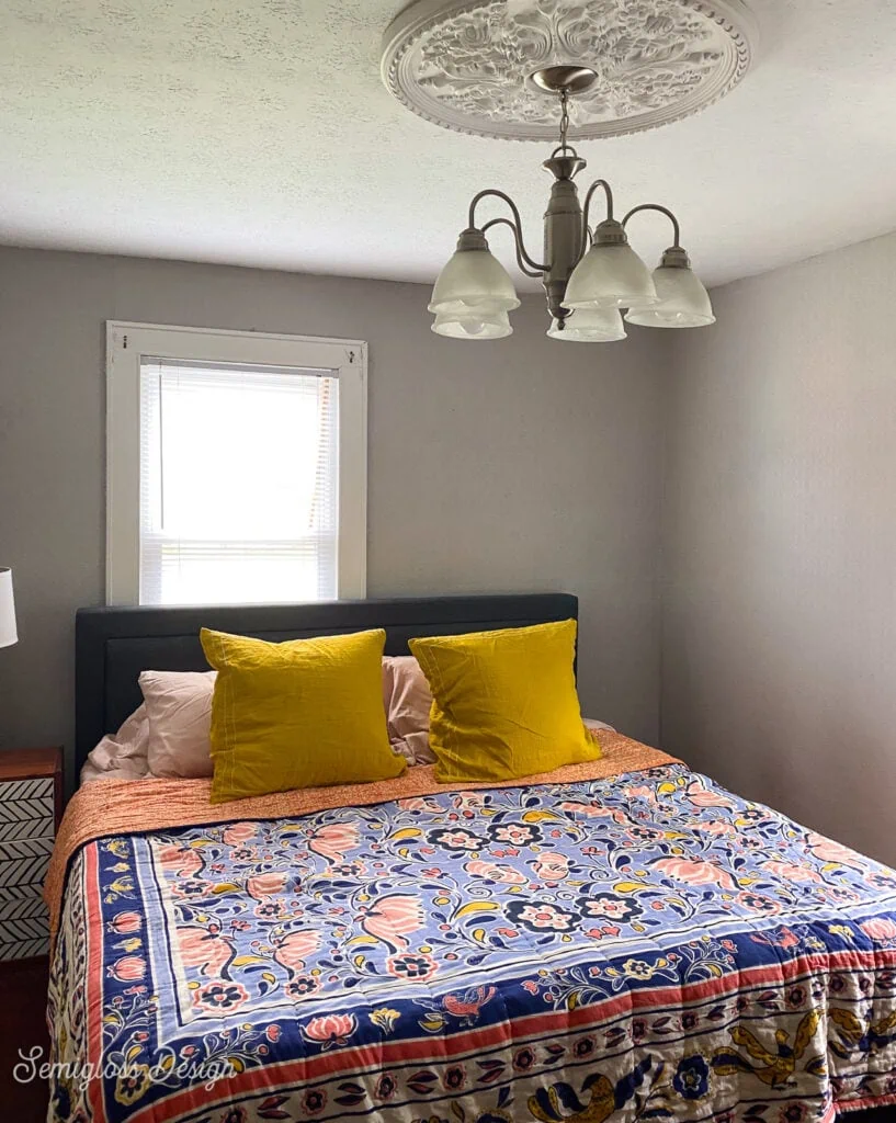 bedroom with colorful quilt and pillows