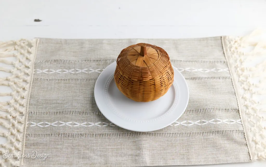 macrame trim placemats and plate with wicker pumpkin