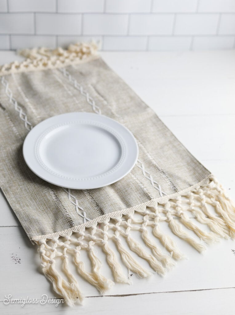 placemat with macrame trim and white plate