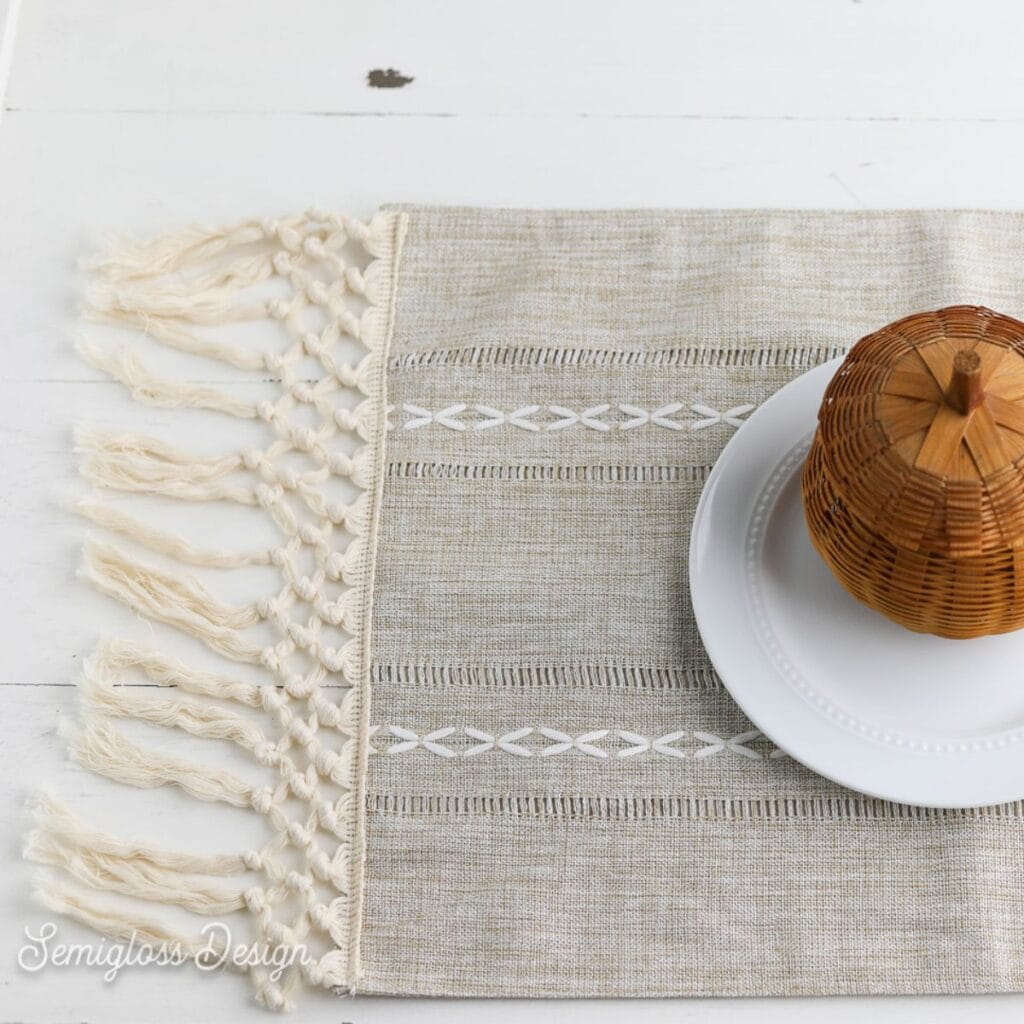macrame placemat with plate and wicker pumpkin