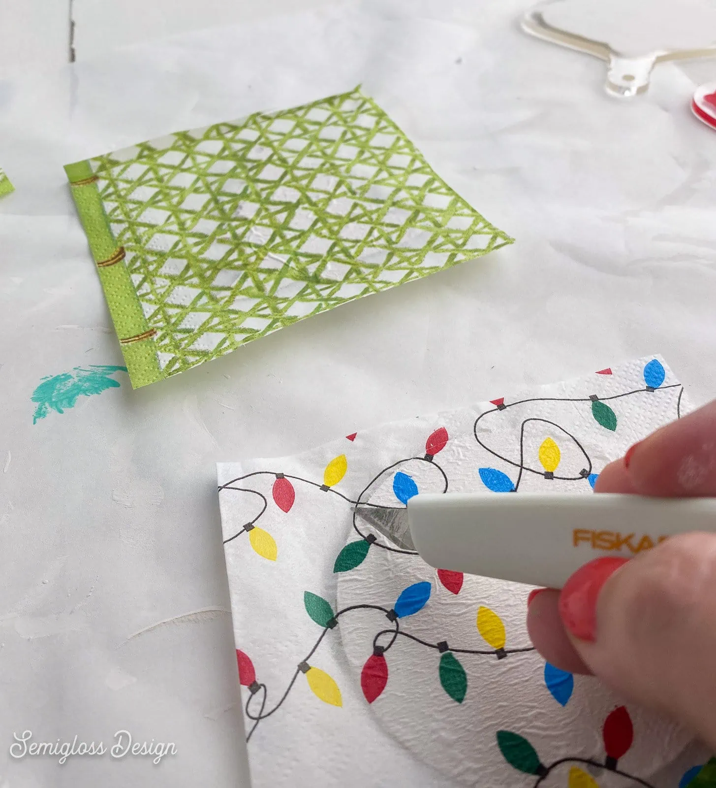 using exacto knife to remove excess paper from ornament