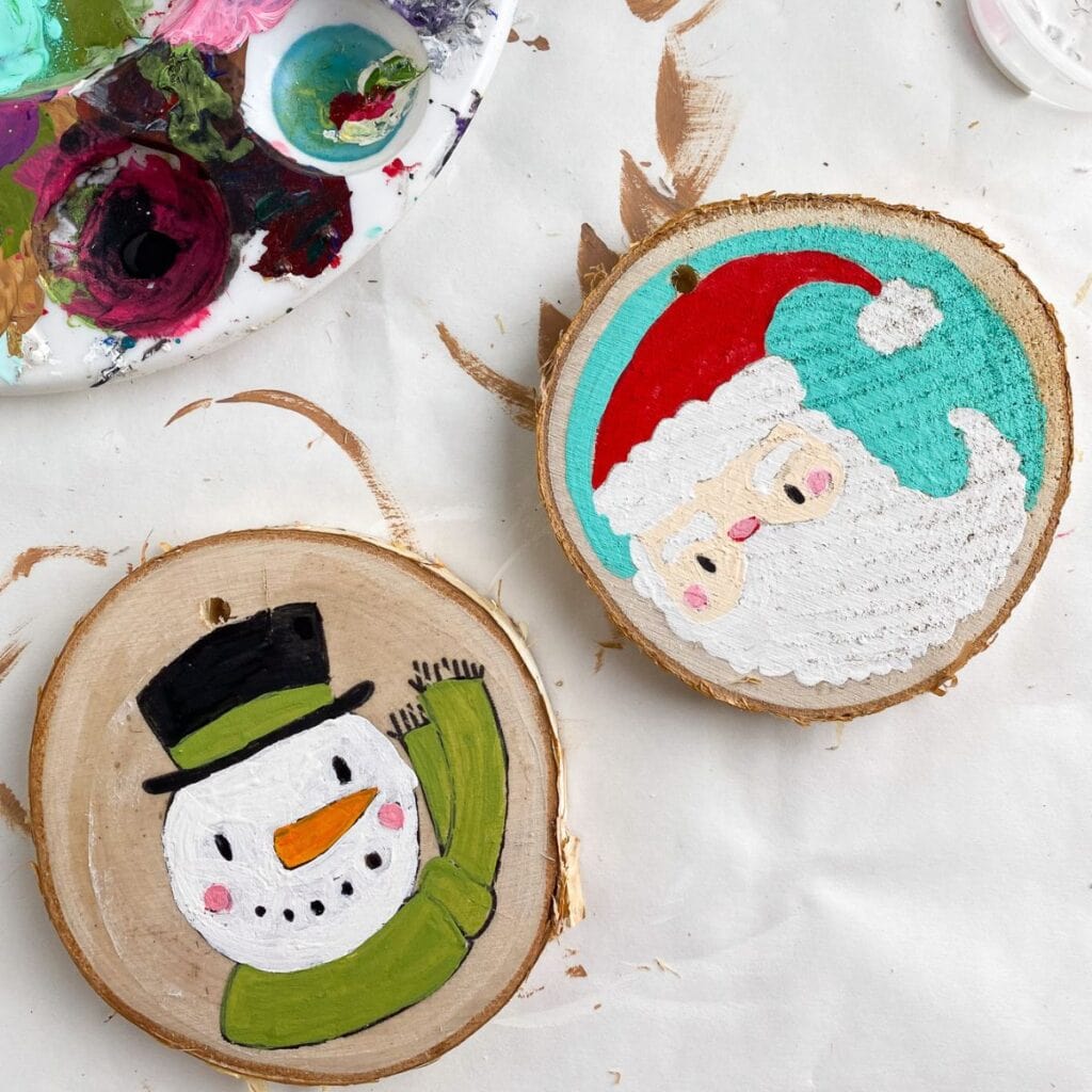 log slice ornaments with snowman and Santa