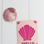 seashell card and shell on wood background