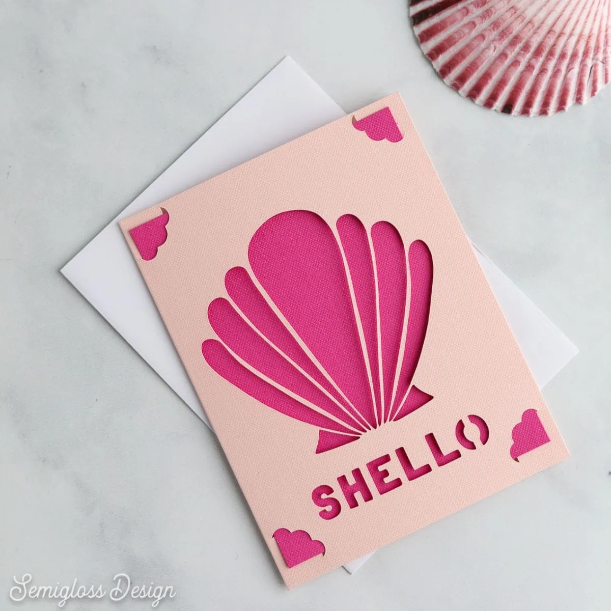pink card with seashell