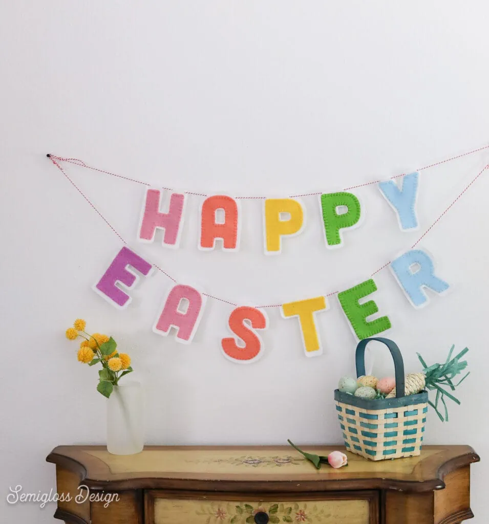 felt happy Easter banner over table with easter basket